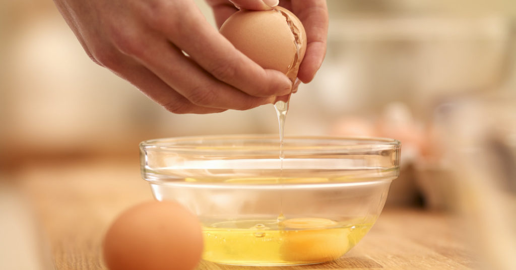 Woman cracking egg